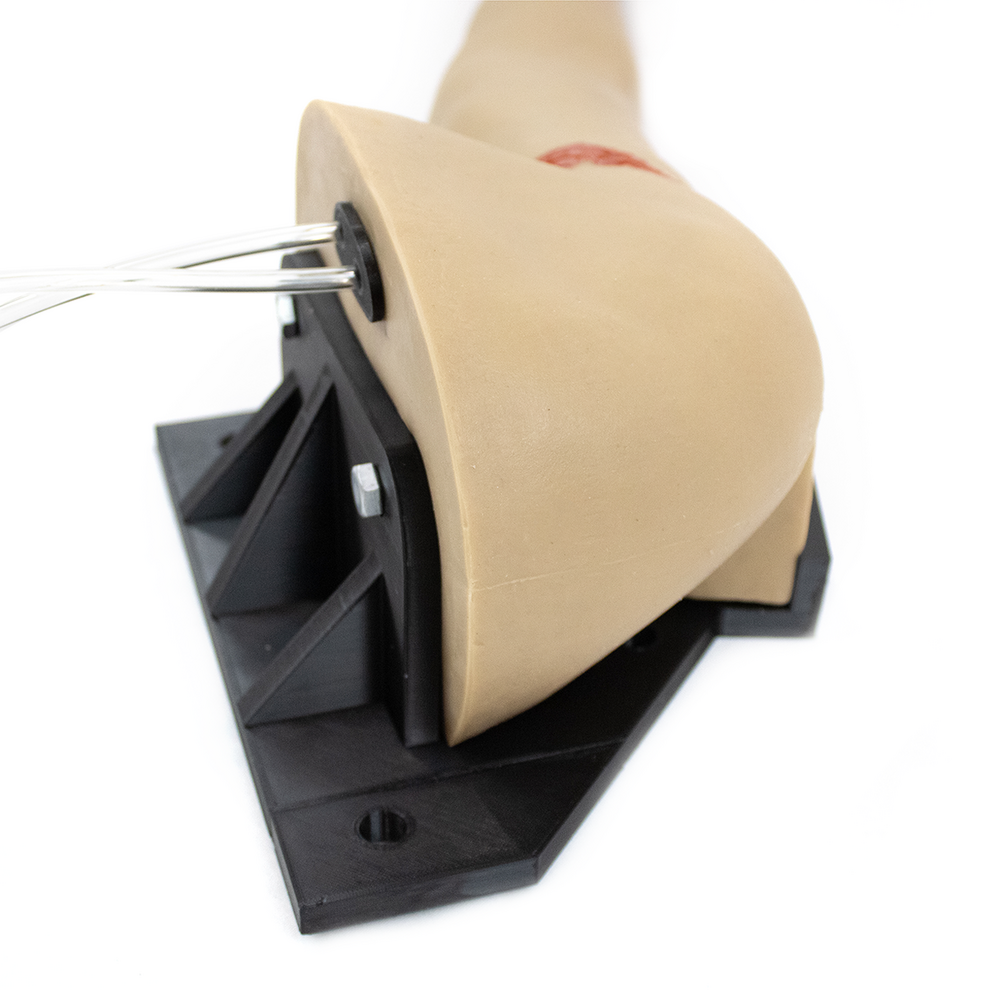 TRAUMASIM Arm Haemorrhage Control Stabilising Bracket showing arm immobilisation device for realistic tourniquet and wound packing simulation training