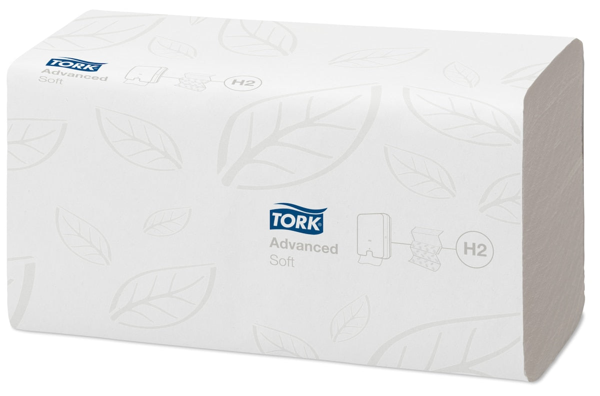 Stack of white Tork multifold hand towels with a faint leaf emboss pattern and the Tork Advanced Soft H2 marking printed on the top sheet