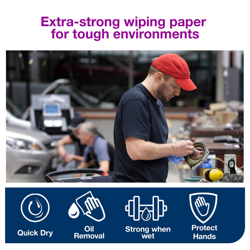 Mechanic in a navy shirt and red cap wipes a metal engine housing with a blue Tork sheet in a busy vehicle workshop, purple heading reading extra-strong wiping paper for tough environments above icons.