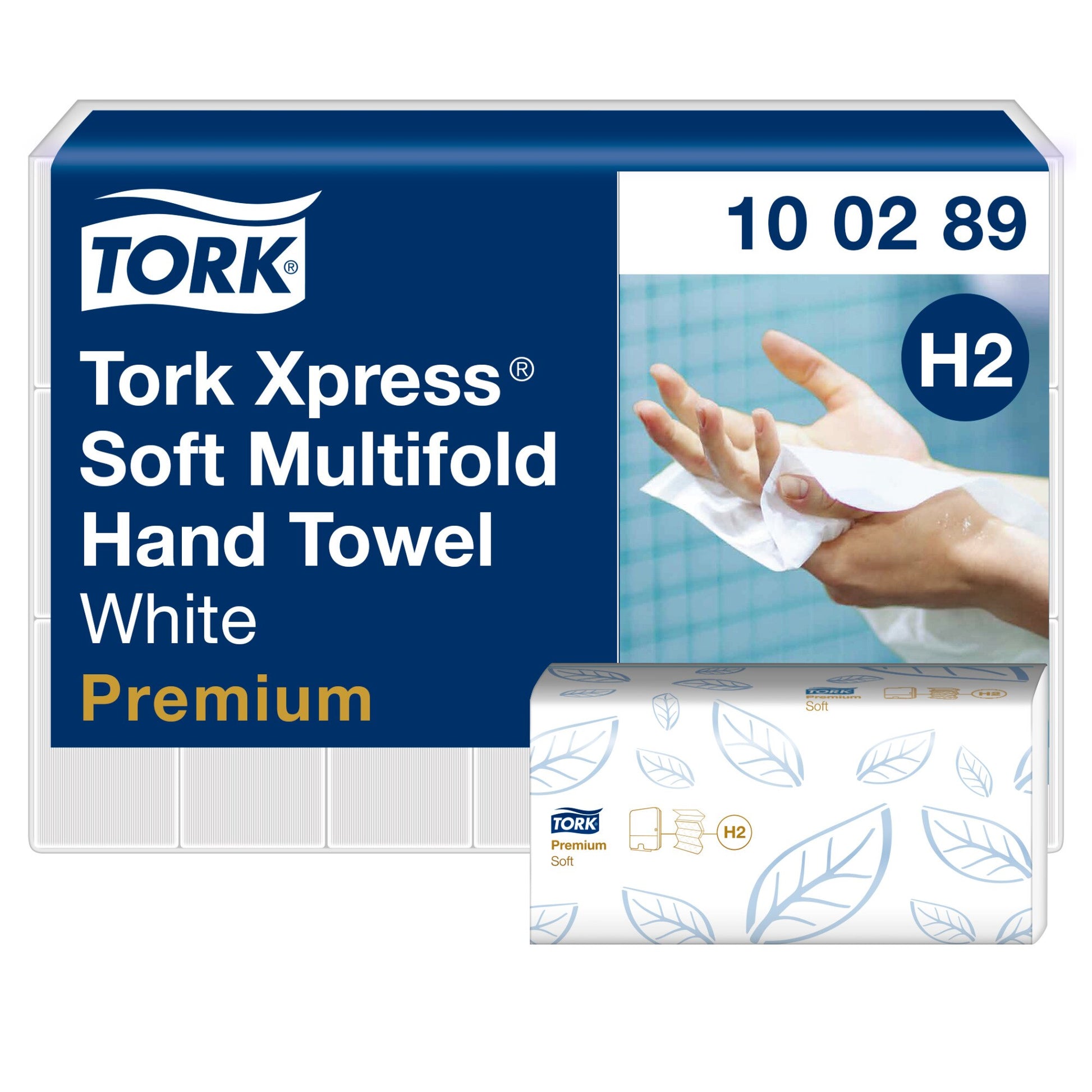 Wrapped bulk pack of Tork Xpress Soft Multifold Hand Towel in white and navy livery, code 10 02 89 and H2 badge, photo of hands drying on the label, with a single blue leaf printed towel sleeve in front.