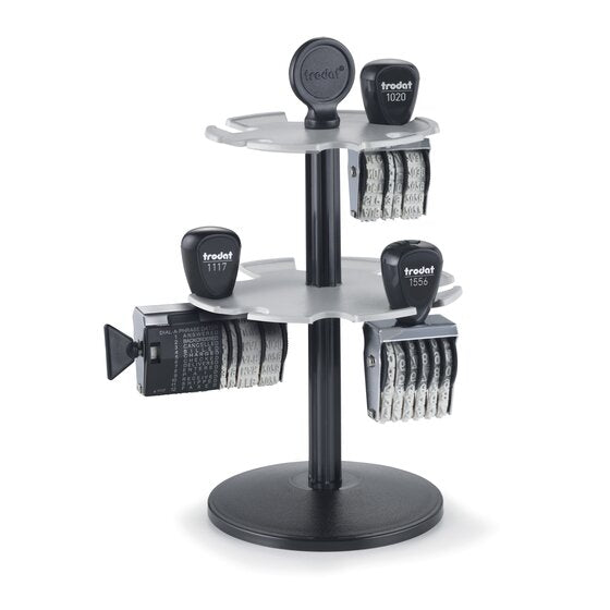 Trodat 3014 two tier stamp rack with a round black base, central column and grey scalloped tiers, holding classic line hand stamps by their handles