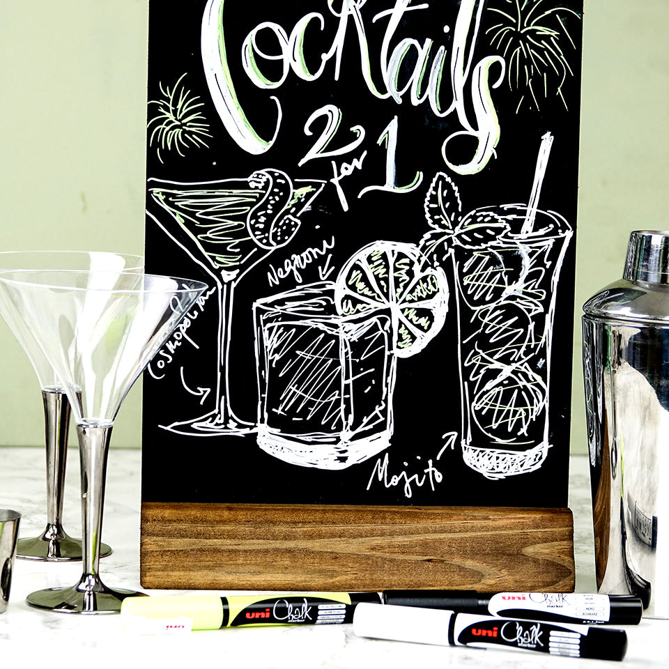 White uni chalk marker lettering on a cafe cocktail chalkboard, with PWE-3MS markers beside it