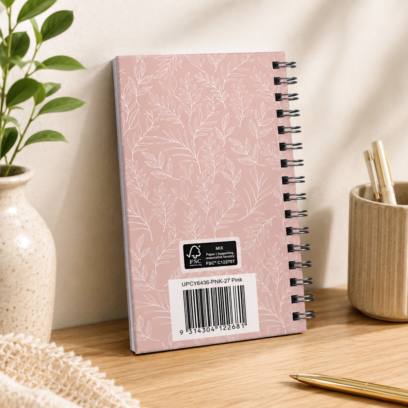 Rear view of the diary standing upright, highlighting the soft pink botanical hardcover pattern, durable wire O binding, FSC certification label and product barcode. The elegant finish complements both home and professional office environments.