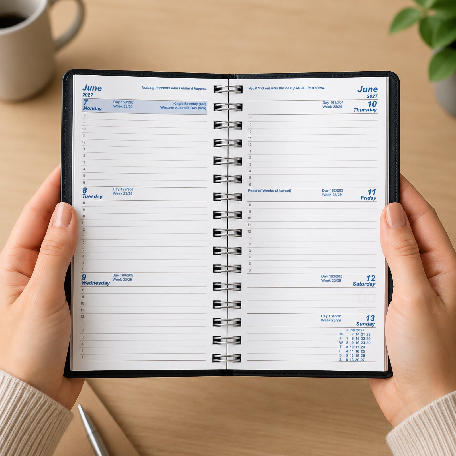 A user holds the Upward University 2027 A6/7 Week To View Diary open to display the weekly planning layout. The clear week to view format provides dedicated space for appointments, classes, reminders and tasks, while the Wire O binding allows the diary to lay flat for comfortable writing and organisation.