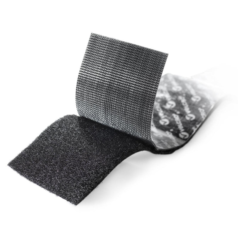Close up view of black heavy duty Velcro Brand hook and loop tape showing reinforced fastening texture and strong adhesive backing.