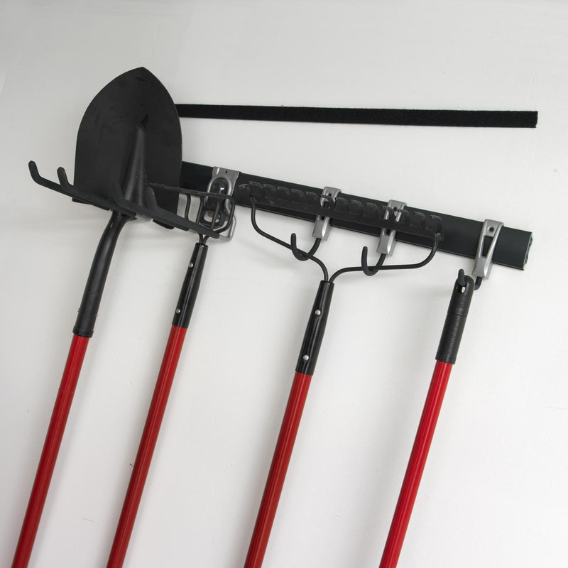 Heavy duty Velcro Brand hook and loop tape installed on a wall holding multiple garden tools and storage hooks in an organised garage setup.