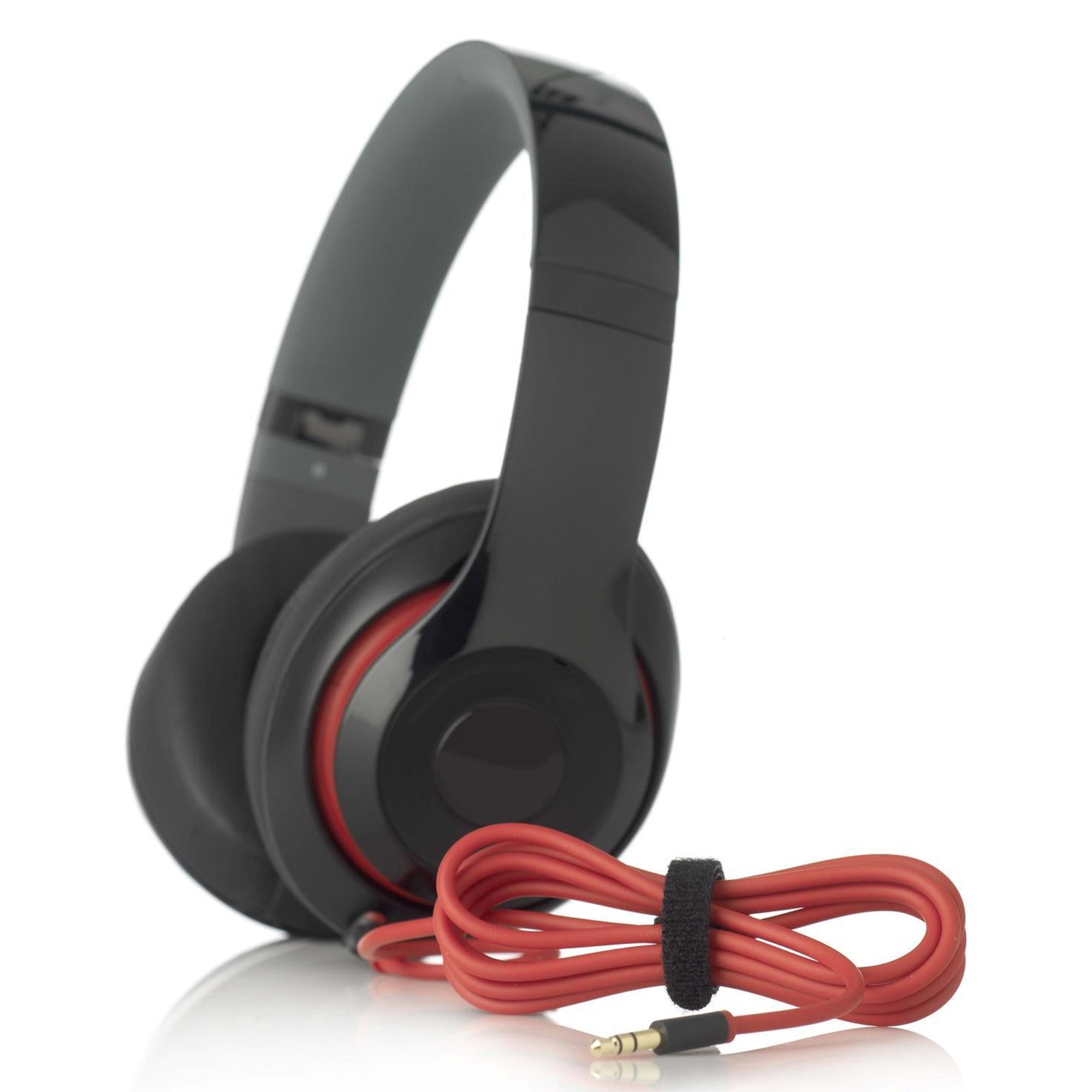 Black over ear headphones displayed with a neatly wrapped red cable secured using a reusable VELCRO Brand cable management tie for tidy storage.