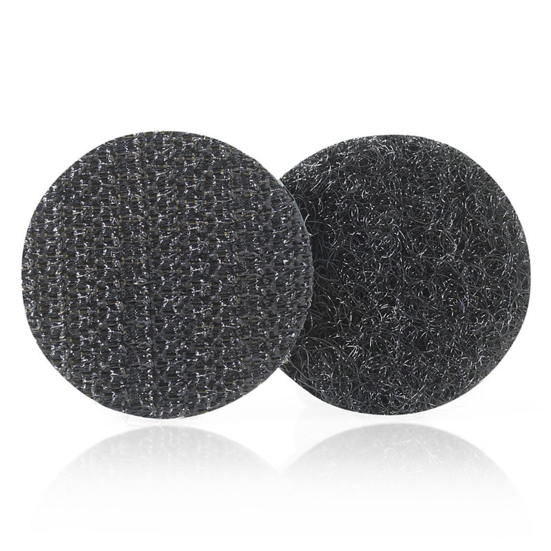 Front view of black circular VELCRO Brand hook and loop dots against a white background showing the hook side and loop side textures used for secure indoor fastening.