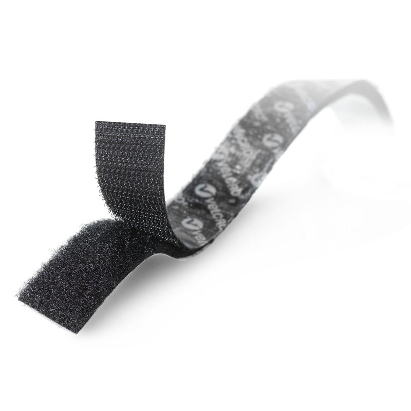 Close up image of black Velcro stick on hook and loop tape showing the textured fastening surfaces and adhesive backing. The image highlights flexible peel and stick construction for everyday organisation tasks.