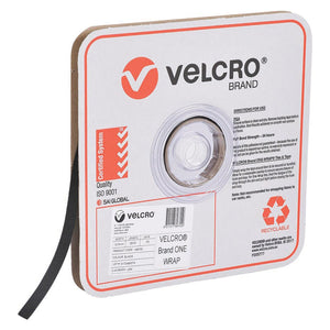 Velcro Brand V189755 black One-Wrap 12mm strap on a roll in a square Velcro Brand box, with the black strap running out of the box and a product label on the front