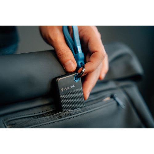 Hand pulling the Verbatim Pocket SSD from a bag by its blue cable loop