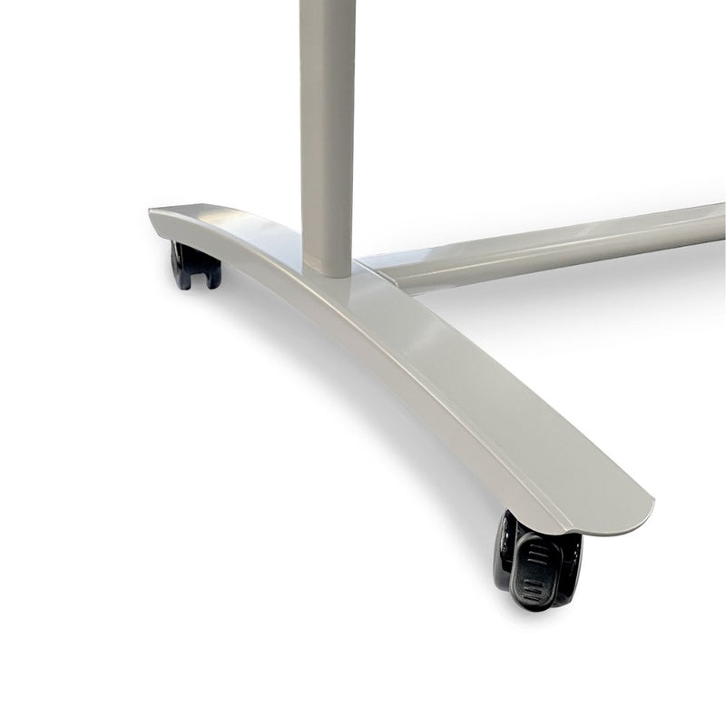 Close up of one curved silver base leg of the Chilli frame with its black twin wheel castor, photographed against a white background.
