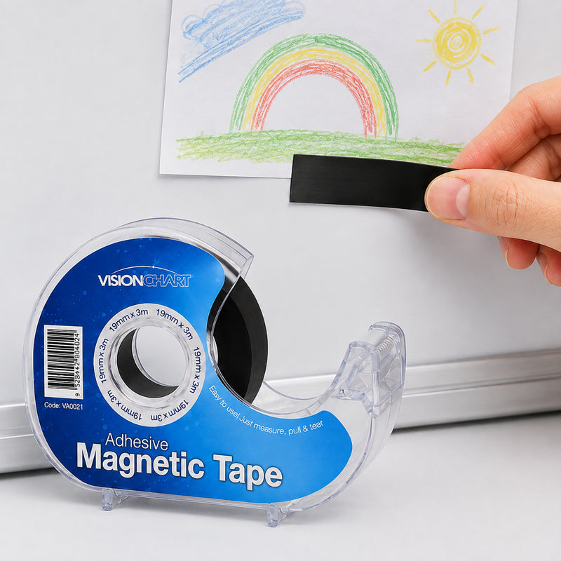 A hand applies a strip of Visionchart self adhesive magnetic tape to the back of a child's drawing before attaching it to a magnetic whiteboard. The image demonstrates the tape's simple peel and stick application for displaying artwork and lightweight documents.