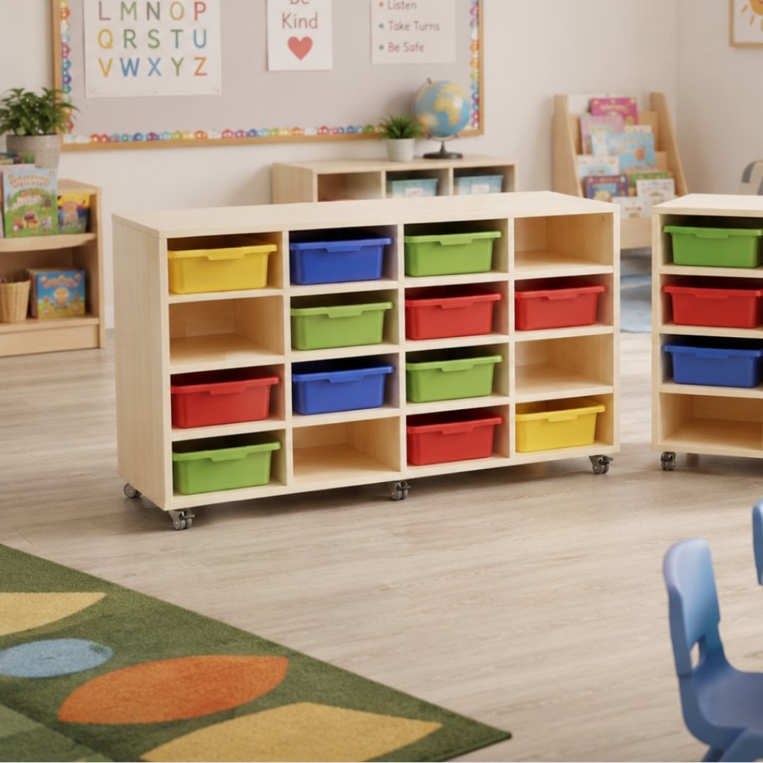 Visionchart EMTT16 trolley set up in a classroom, its bays filled with coloured trays, standing on a patterned floor rug with an alphabet display on the wall behind.