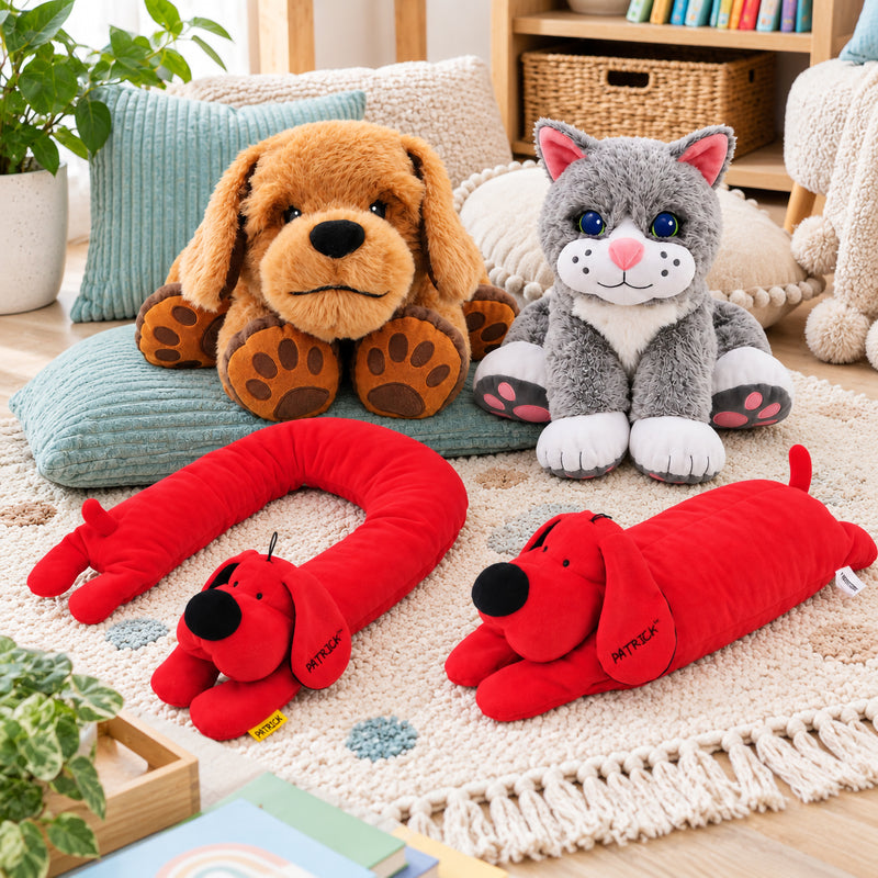 Complete MTA Essentials Weighted Therapy Pets Kit arranged in a calm classroom style environment. The collection shows Theo the brown Therapy Dog, Chloe the grey Comfort Cat, the long red Patrick shoulder pad and the red Patrick lap pad, highlighting the different shapes and sizes available for sensory and calming routines.