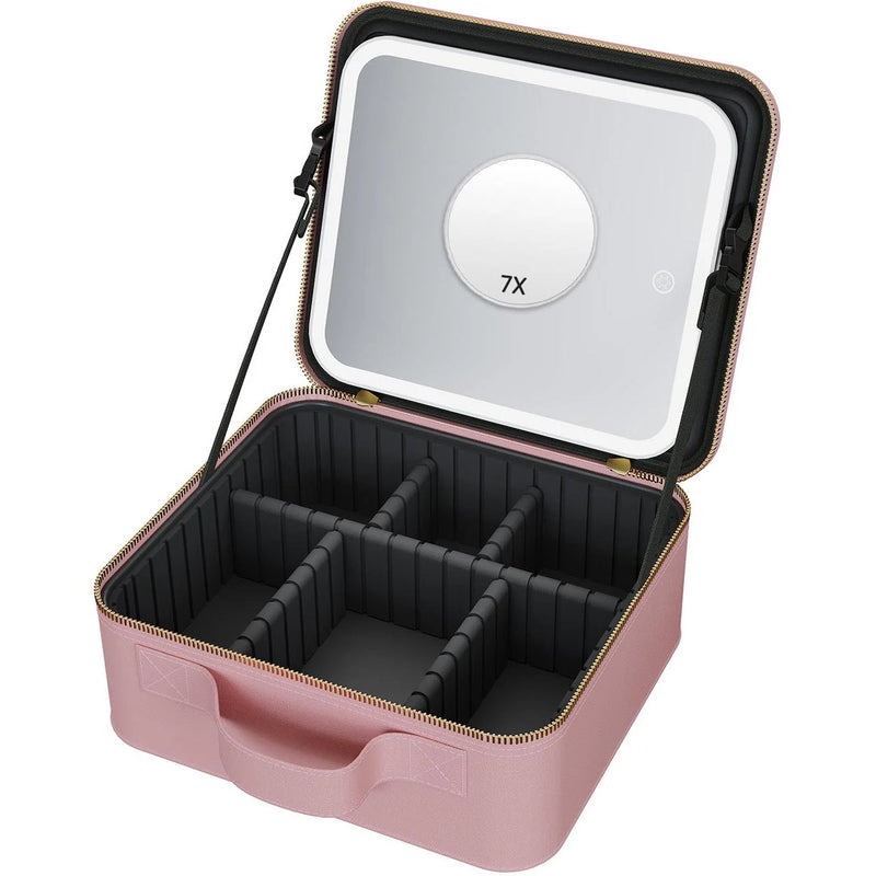 Pink Wellcare cosmetic bag open with the lit LED mirror and round 7X magnifier in the lid and empty dividers below, on white
