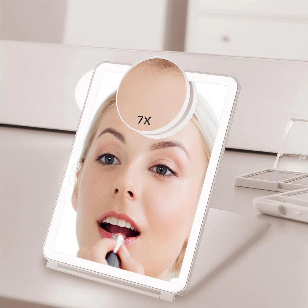 Woman applying lipstick in the lit Wellcare foldable makeup mirror with the 7X magnifier, standing on a vanity