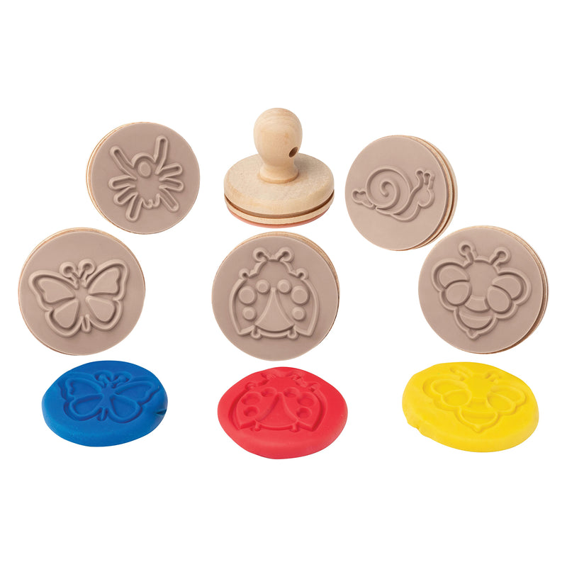 Flat lay display of the Educational Colours Wooden Dough Stamps Bugs collection showing six wooden bug stamps with detailed impressions pressed into bright modelling dough pieces.
