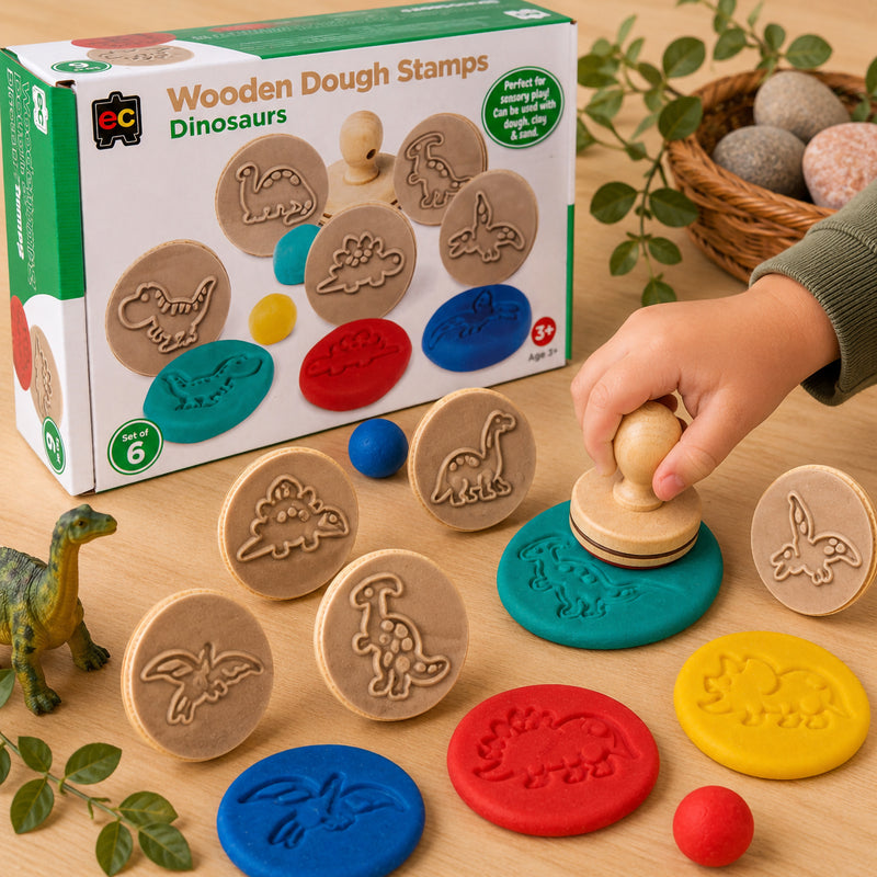 Child using Educational Colours Dinosaur Wooden Dough Stamp set with colourful modelling dough and prehistoric stamp patterns in a sensory learning environment.