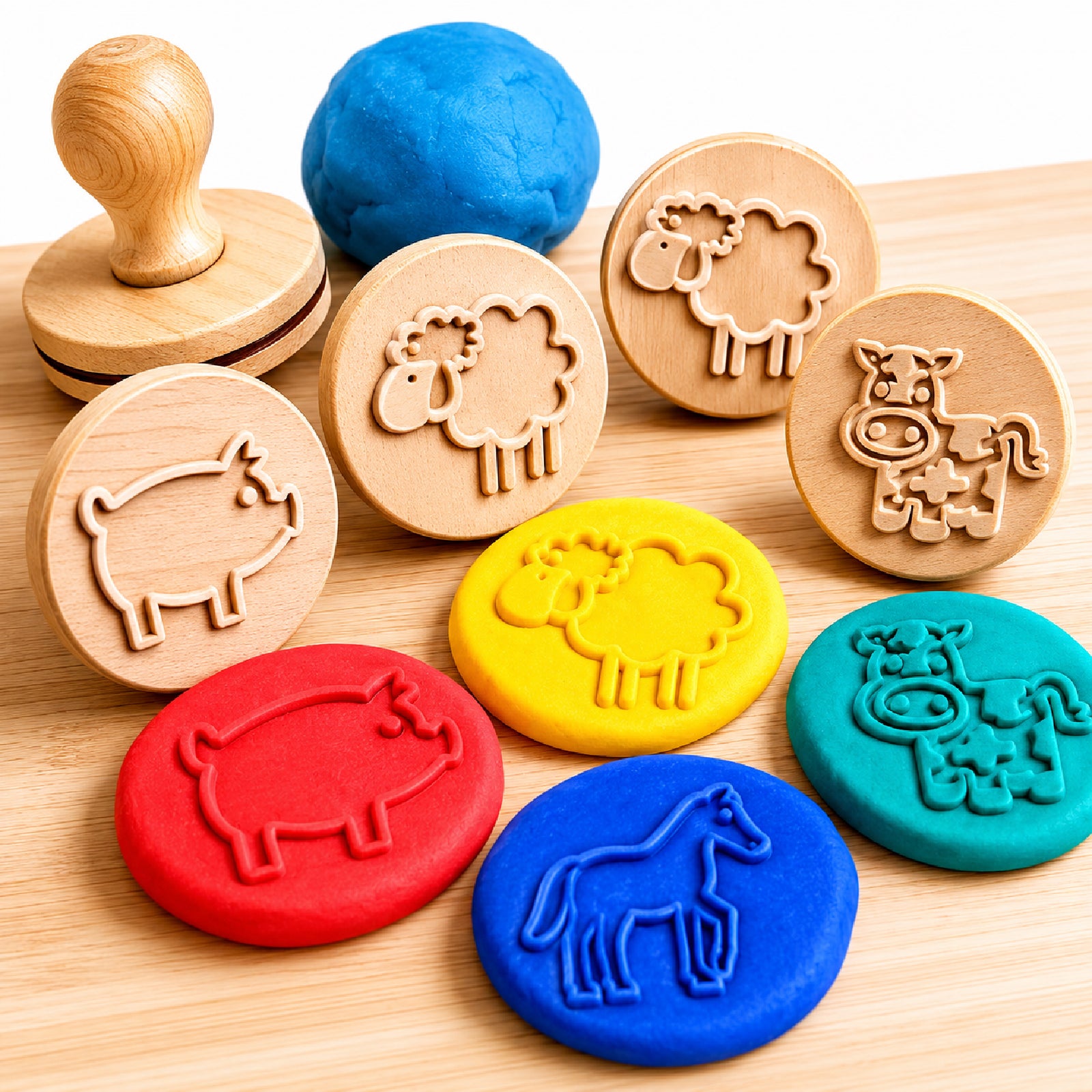 Close up view of Educational Colours Wooden Dough Stamps Farm Animals set displaying wooden animal stamps beside colourful dough impressions on a wooden surface. The image highlights sheep, pig, horse and cow designs created through sensory dough play activities for children.