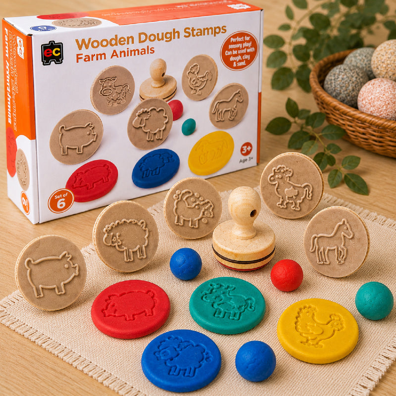 Complete Educational Colours Wooden Dough Stamps Farm Animals set arranged on a textured mat with colourful dough impressions and packaging visible in the background. The image showcases all six farm animal designs and demonstrates creative sensory play for preschool learning environments.