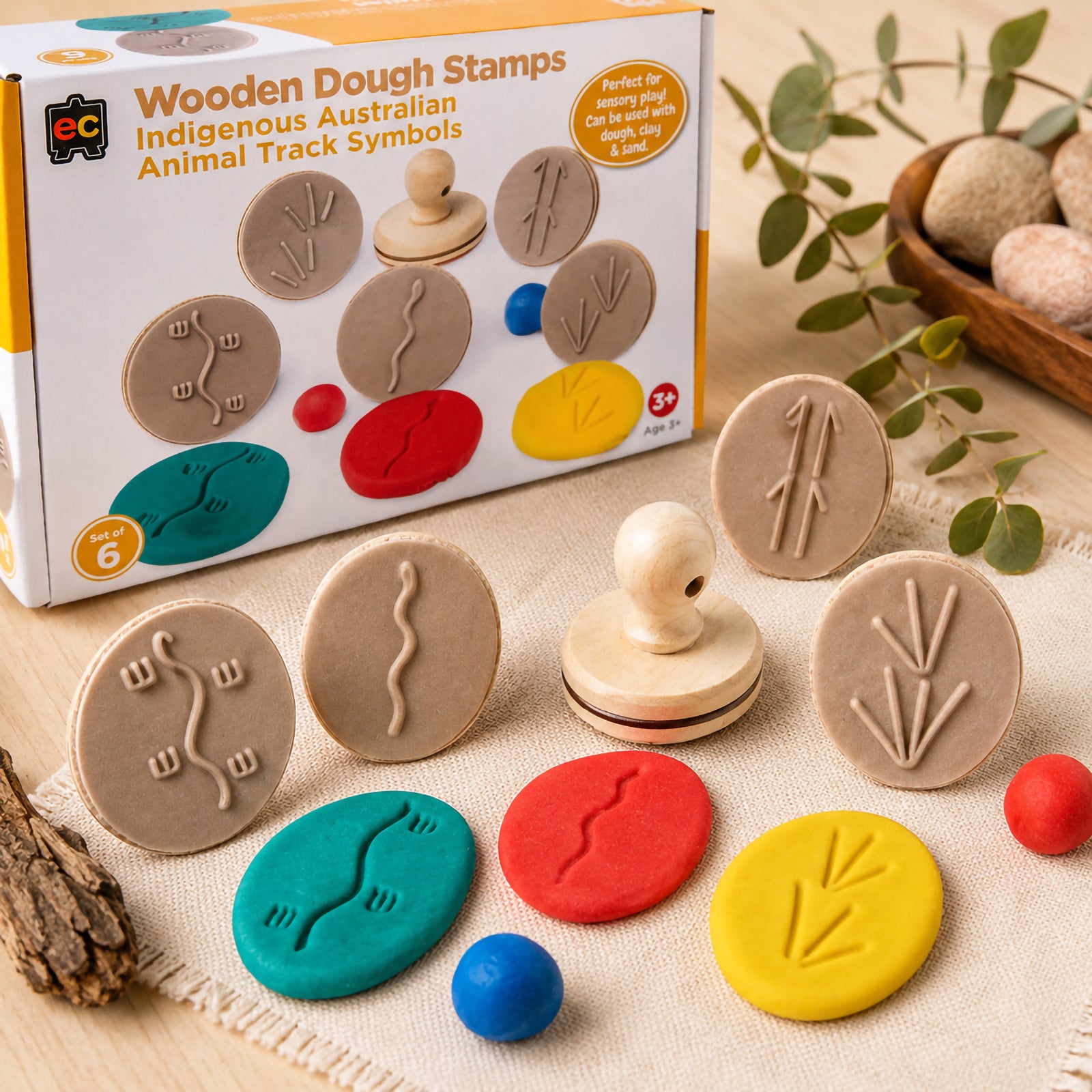 Educational Colours Wooden Dough Stamps Indigenous Ani Track set displayed with product packaging, textured sensory dough pieces, and six wooden stamps featuring Indigenous Australian animal track symbols in a natural learning environment.