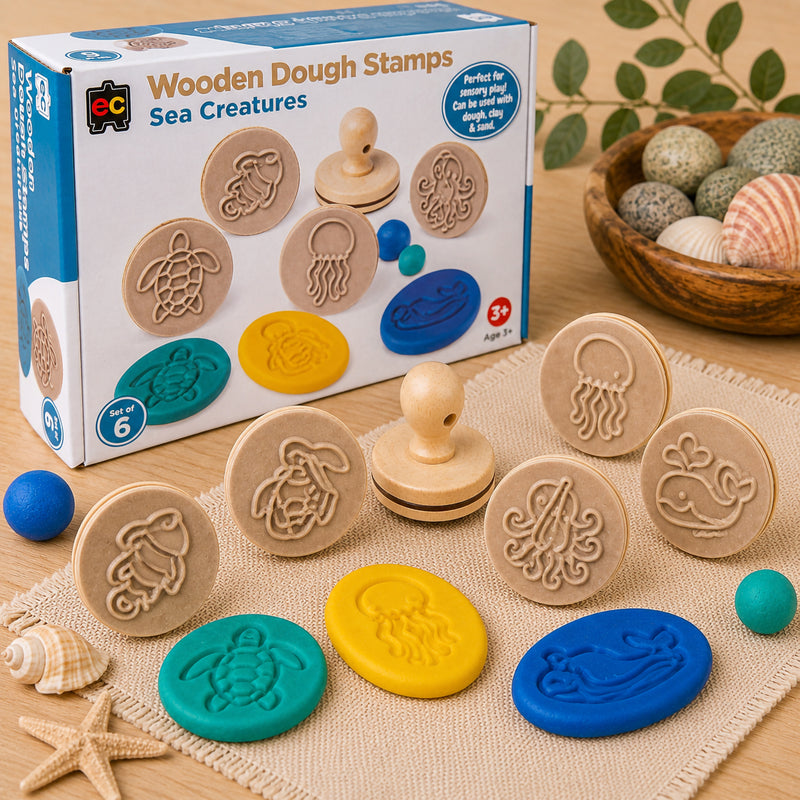 Educational Colours Wooden Dough Stamps Sea Creatures set arranged with retail packaging, wooden marine animal stamps and colourful dough impressions on a textured mat. The image highlights ocean themed sensory play and imaginative learning for children.