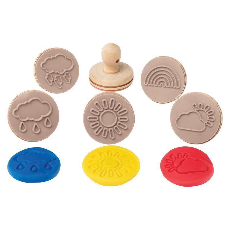 Close up display of weather themed wooden dough stamps with matching colourful dough impressions including sunshine, rainbow, clouds and rain symbols. The image highlights the detailed stamp patterns and child friendly sensory learning design.