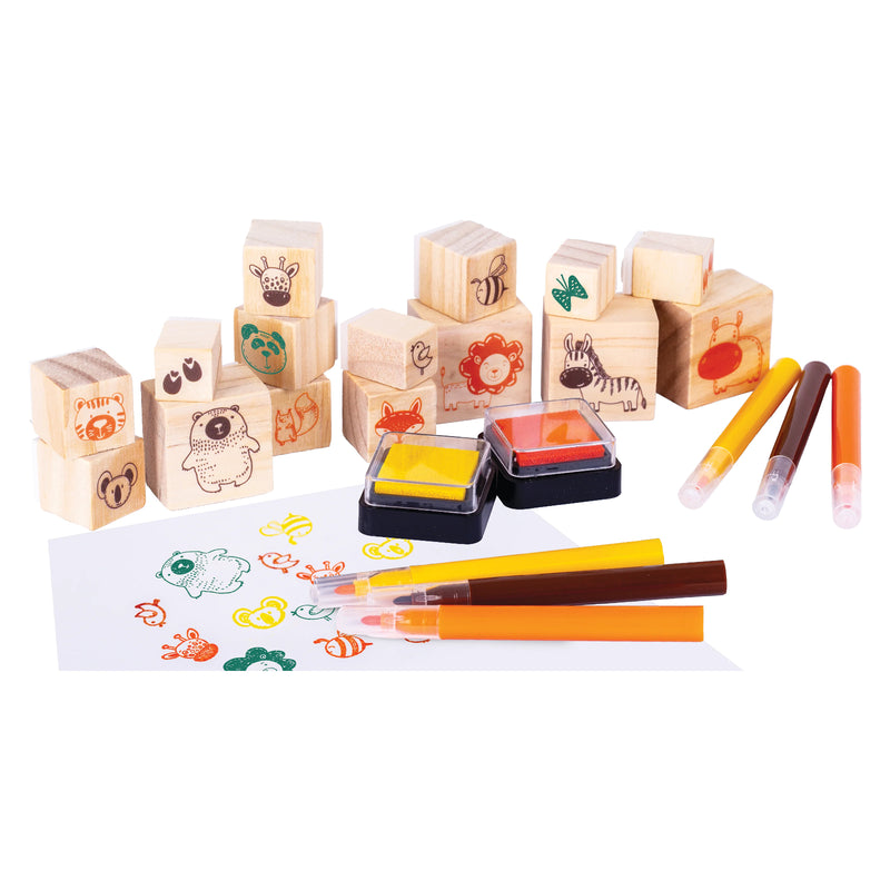 Wooden animal themed stamp set featuring assorted wooden blocks, coloured ink pads, and markers arranged beside stamped artwork showing playful animal illustrations and decorative patterns.