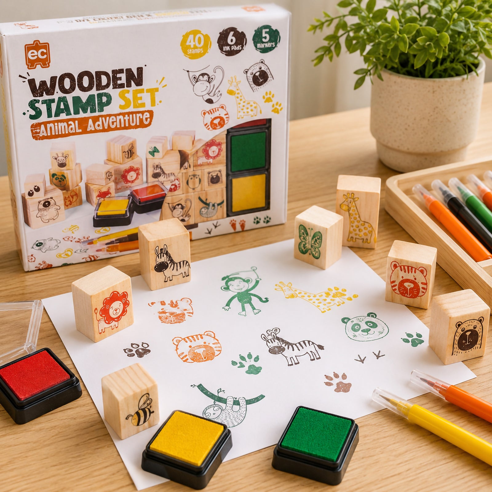 Educational Colours Wooden Stamp Set All About Animals packaging displayed beside wooden animal stamps, colourful ink pads, markers, and completed stamped animal artwork for classroom and home craft activities.