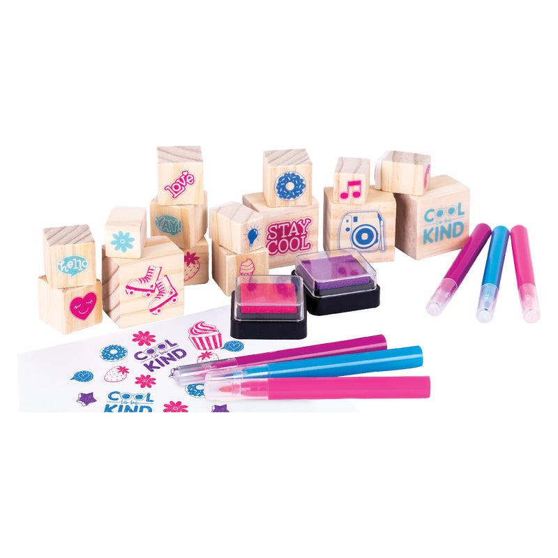 Product display featuring Good Vibes wooden stamps, colourful markers, and vibrant ink pads with positive sayings and playful designs arranged for arts and crafts activities.