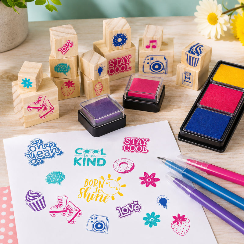 Wooden Stamp Set Good Vibes! arranged on a tabletop with colourful stamps, vibrant ink pads, and markers displaying positive phrases, sweet treats, flowers, and creative decorative icons for children’s crafts.
