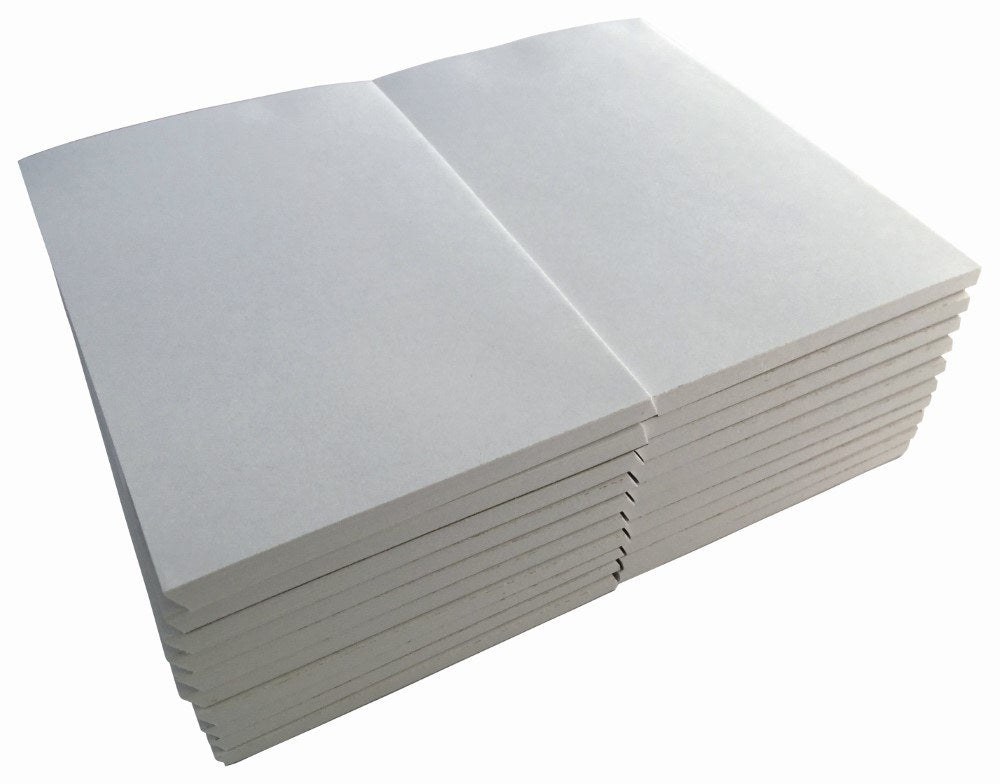 Two stacks of plain white Writer 6 x 4 inch office pads, unwrapped, photographed on an angle against a white background