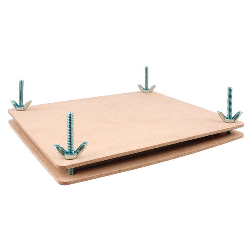 Close-up of Zart flower press with cardboard and white cotton paper sheets laid out