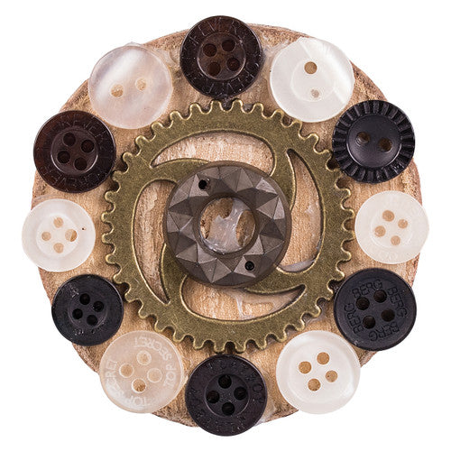 Small and large bronze metal cogs side by side for size comparison