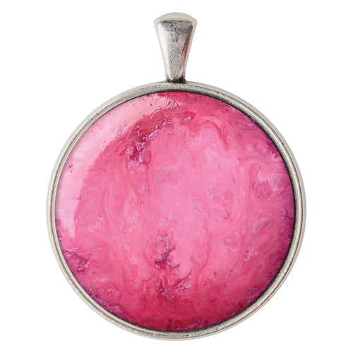 Silver cabochon settings arranged with glass cabochon pieces alongside