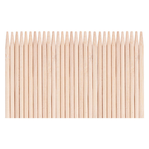 Child using wooden stylus to scratch a Christmas tree shape