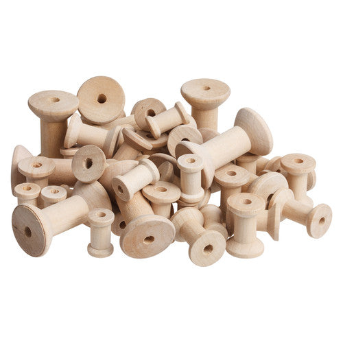 Zart natural wooden spools in three assorted sizes spread on a white surface