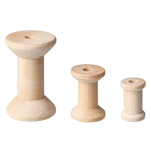Close-up of unfinished wooden spools showing natural wood grain texture