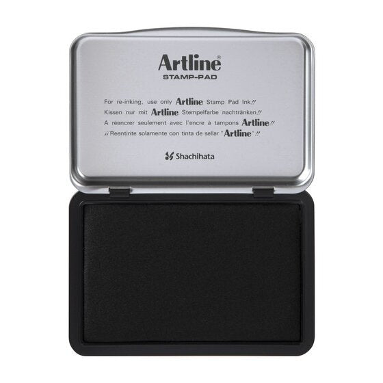 Artline stamp pad open, the silver lid printed For re-inking, use only Artline Stamp Pad Ink, over a black inked pad