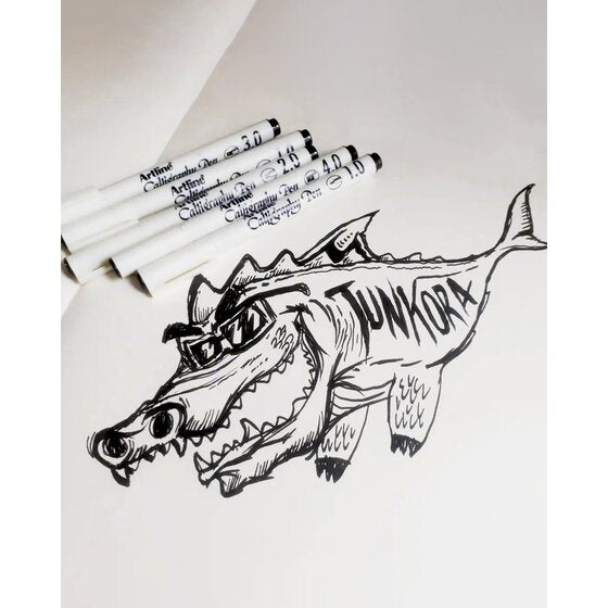 Black line drawing of a crocodile with black Artline Calligraphy Pens lying beside it