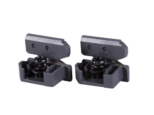 Two dark gray plastic and metal mounting clips or brackets shown side by side on a plain white background.