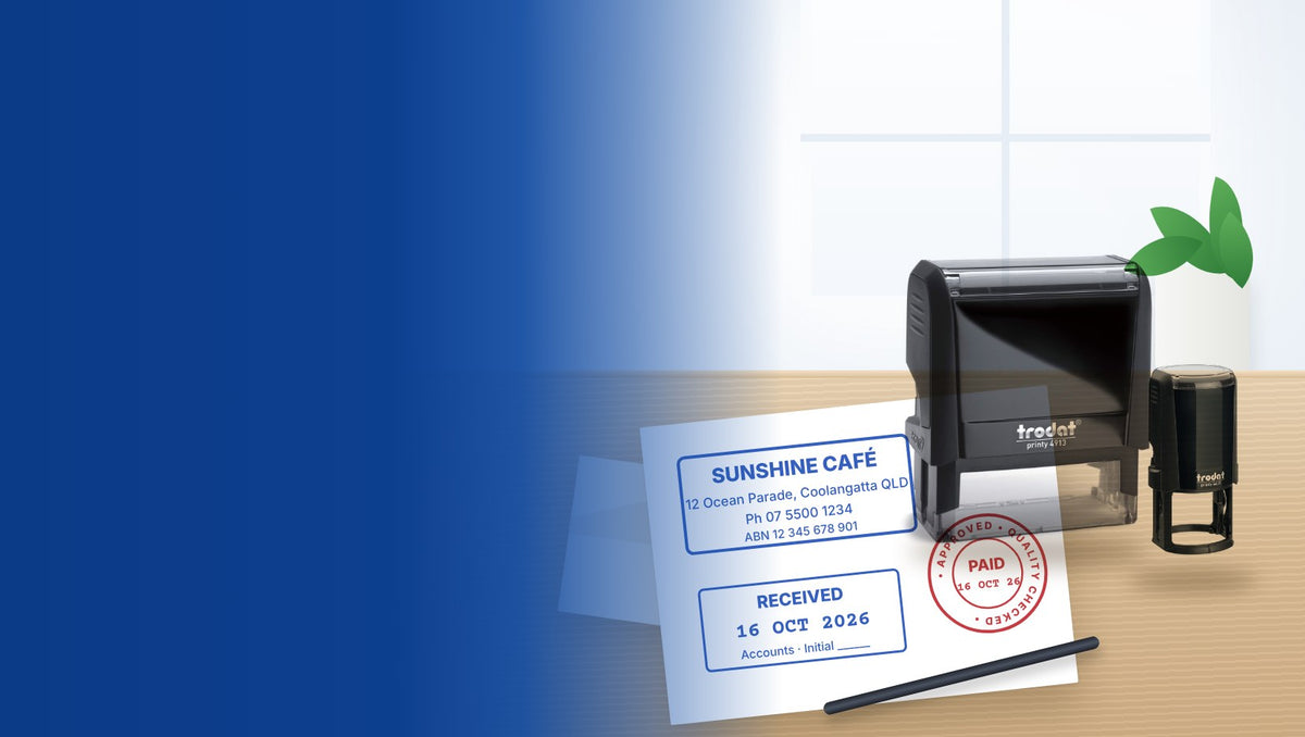 Trodat Printy custom self-inking stamps on a desk with stamped address, received and paid impressions