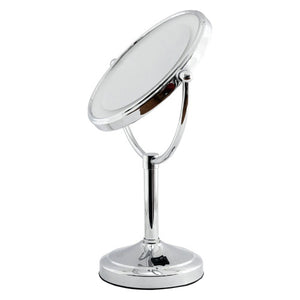 Dolphy LED tabletop magnifying mirror in silver, round mirror with a lit ring tilted on a pedestal with a switch on the round base