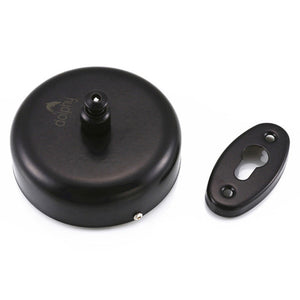 Dolphy retractable single clothesline in black, round unit with the cord knob on top, shown beside the black wall bracket