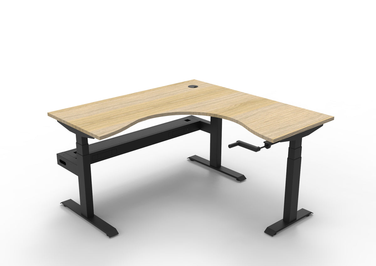 Rapidline Boost Crank manual height adjustable corner workstation, E0 rated Natural Oak top on a black satin powdercoated frame. Supplied product image for model BCCNRCT1P1515 NO/BL. View 1.