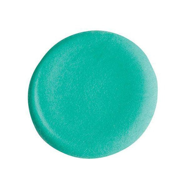 Close view from above of a smooth round disc of turquoise Paper Magiclay modelling clay on a white background