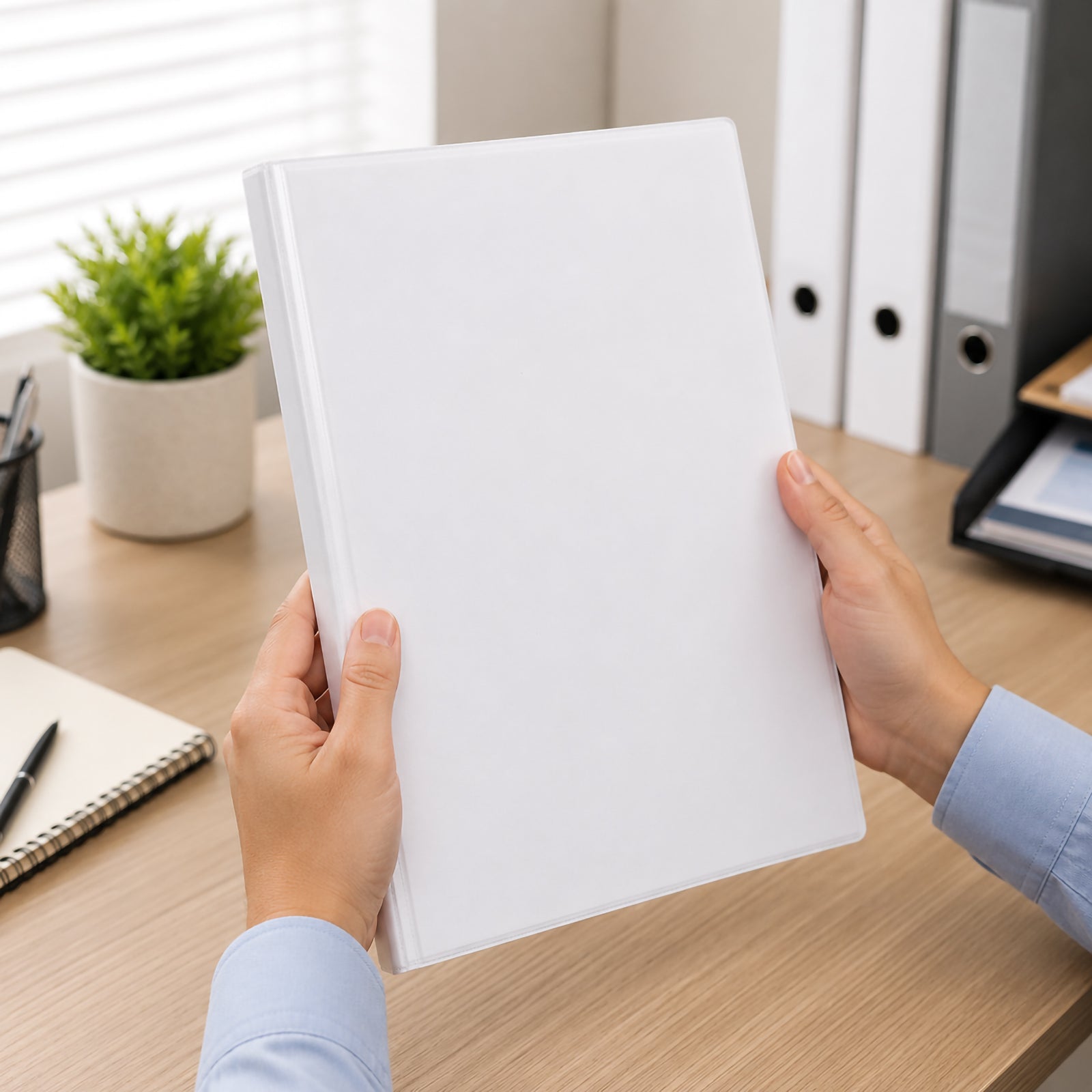 Hands holding the Marbig Clearview Insert Binder A4 19mm 4D Ring White in a bright office workspace, highlighting the professional white finish, slim profile and comfortable everyday handling for presentations and filing.