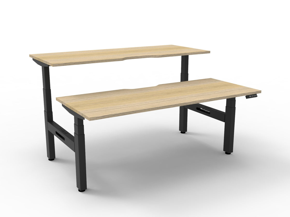 Rapidline Boost Plus electric height adjustable back to back workstation, E0 rated Natural Oak top on a black satin powdercoated frame. Rapidline range image supplied for model B+2P1575 NO/BL.