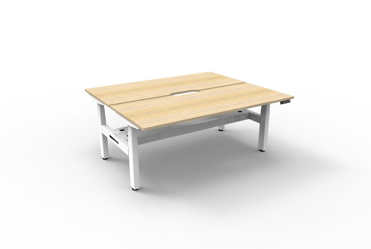 Rapidline Boost Plus electric height adjustable back to back workstation, E0 rated Natural Oak top on a white satin powdercoated frame. Rapidline range image supplied for model B+2PCT1575 NO/WS.